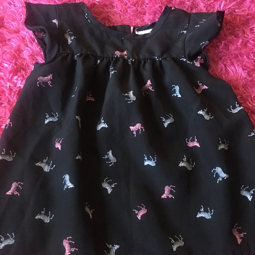 Girls adorable navy zebra top with back zipper.